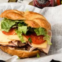 The Hampton · Honey maple coated turkey with chipotle gouda on a toasted croissant, dressed with lettuce, ...