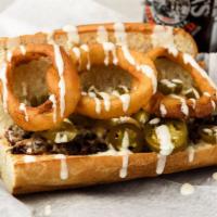 The Mason Dixon · Cajun roast beef, melted American, jalapeños, ranch dressing, and onion rings on a toasted h...