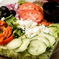 Greek Salad · Red onions, roasted red pepper, black olives, cucumbers and feta on a bed of romaine lettuce.