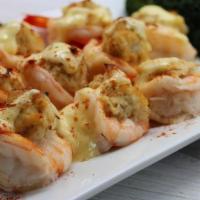 Crab Stuffed Shrimp · 10 butterflied shrimp stuffed with crab meat and broiled then topped with hollandaise and se...