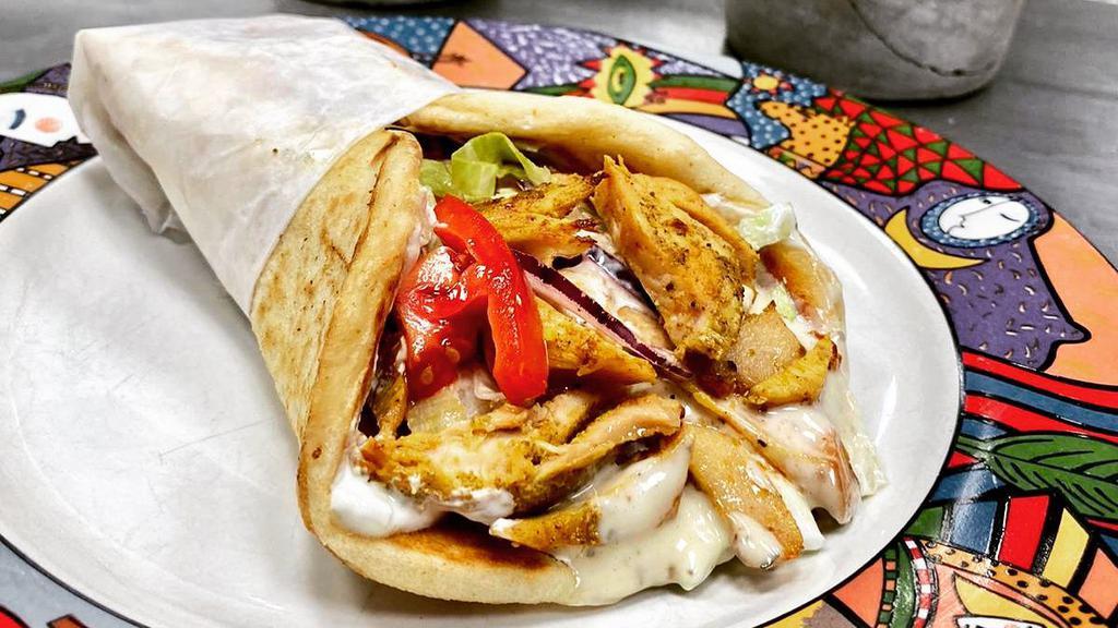 Gyro Chicken · Slow roasted chicken dressed with lettuce, tomato, onion, pickles, and ranch dressing on pita bread.