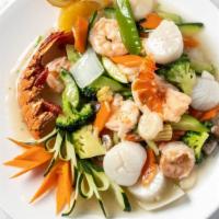Seafood Combination · Jumbo shrimp, scallops, and lobster with veggies in white sauce.