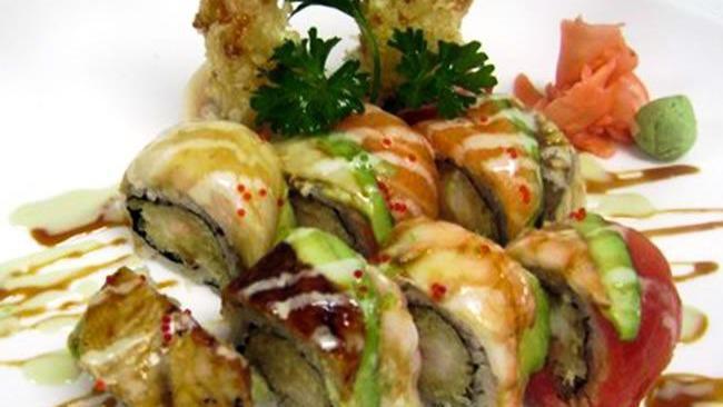 Dragon Roll · Shrimp tempura roll, topped with eel, avocado, sesame seed and eel sauce.
