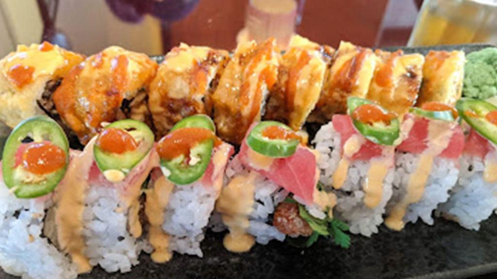 Raleigh Roll · Soft shell crab, cucumber inside, outside with spicy tuna, tempura flakes and eel sauce.