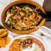 Fajitas Jalisco · Strips of marinated chicken, steak, shrimp, pork tips, chorizo, beef tips, onions, bell pepp...