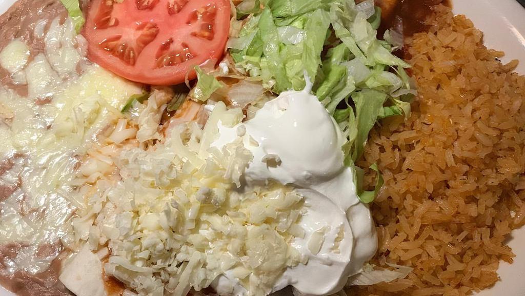 Burrito Supremo · Large flour tortilla filled with choice of protein and topped with lettuce, tomatoes, sour cream and cheese. Served with rice and beans.