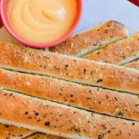 Bread Sticks Galore · 8 pieces of breadsticks freshly baked to a golden brown, covered with Parmesan cheese, olive...
