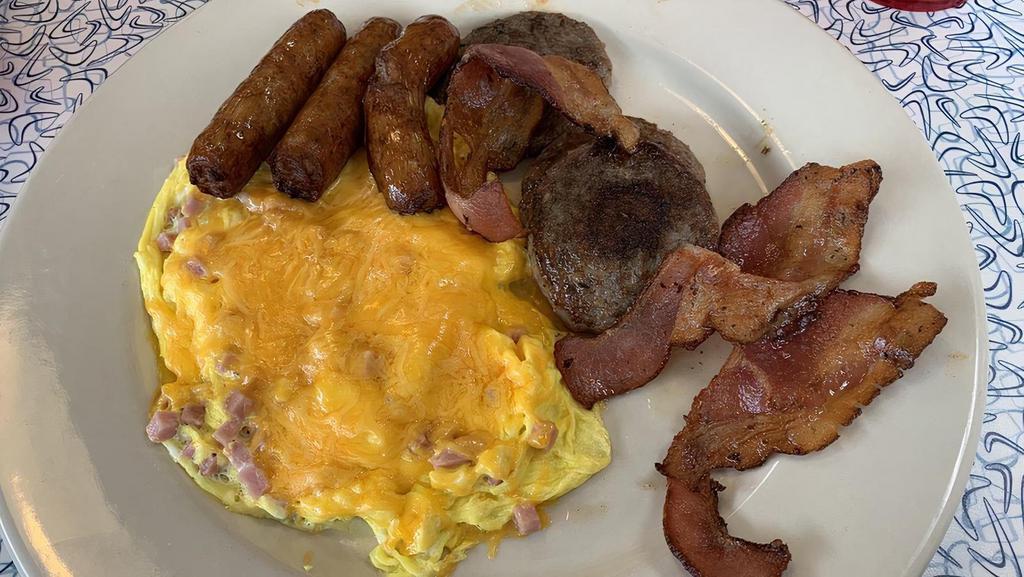 B10 Caveman Combo · Three eggs scrambled with ham and cheddar, three strips of bacon, three sausage patties.