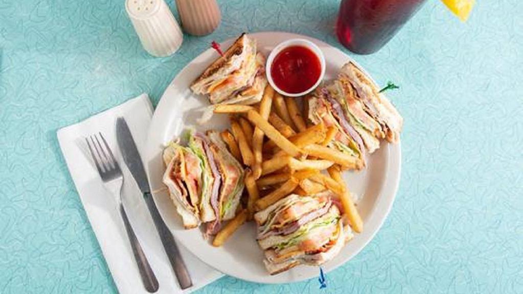 Club Sandwich On Toast · Turkey, ham, bacon, American cheese, lettuce, tomato, and mayonnaise. Served with choice of side.
