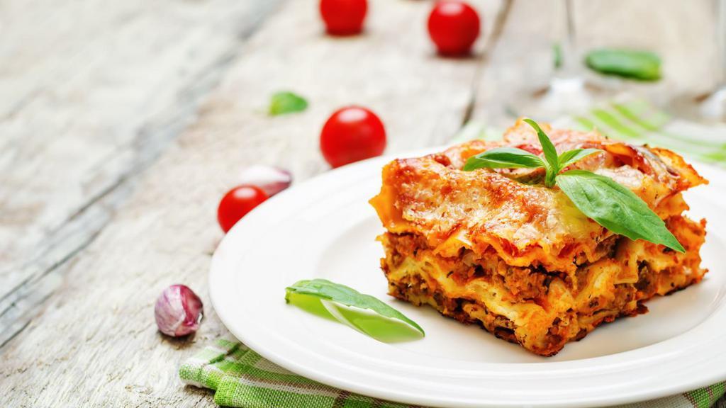 Meat Lasagna · Juicy beef, tomatoes, and mozzarella over layers of beautifully cooked tender pasta with freshly baked breadsticks.