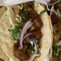 Al Pastor Tacos · Seasoned pork cooked with pineapple on soft corn tortillas with red onion and cilantro. Flou...