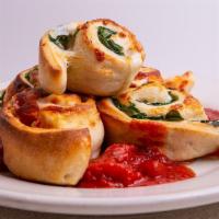 Pinweels · Rolled inside our pizza dough with mozzarella and baked.