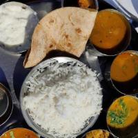 Royal South Indian Thali · White rice, roti, sambar, dal, porial,rasam, yogurt pickle, papad, choice of coffee or tea, ...