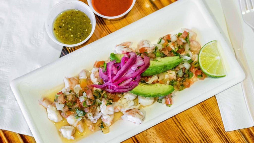 Ceviche Shrimp (Cold) · Shrimp, cured in lime juice, mixed with tomatoes, jalapeno pepper, onions, and cilantro. Topped with avocado slices.