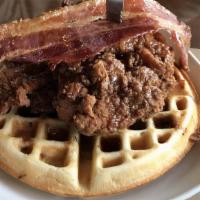 Chicken N' Waffles · Bacon-infused waffle fried chicken thigh, sausage gravy, bourbon maple syrup, candied bacon.