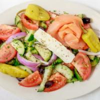 Horiatiki Salad · Greek salad with a combination of tomatoes, peppers, cucumbers, onion and Kalamata olives to...