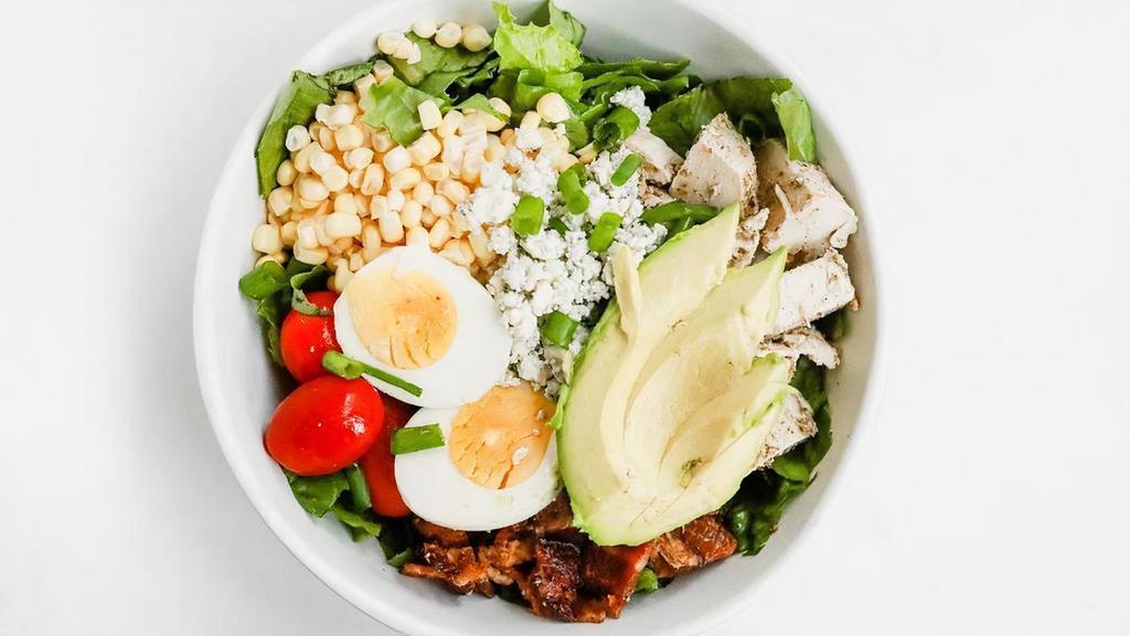 Village Cobb Salad · romaine, chicken, bacon, egg, cherry tomato, avocado, green onion, crumbled blue cheese, raw corn. dressing: village ranch or avo goddess (we will include village ranch unless another dressing is selected)