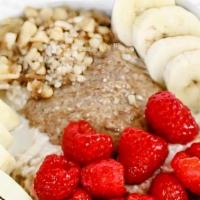 Overnight Oats · gluten free oats soaked in housemade cashew milk, topped with almond butter, strawberries, w...