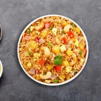 Pineapple Fried Rice · Rice, eggs, pineapple, onions, carrots, and cashew nuts.