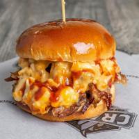 Mac N' Brisket Sandwich · Delicious smoked brisket, topped with mac & cheese, cheddar cheese, and BBQ sauce.