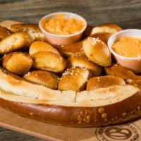 The Monster Pretzel · An extra-large baked Bavarian pretzel topped with pretzel nuggets and comes with beer cheese.