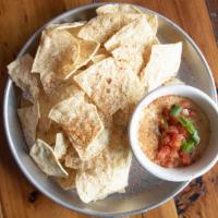 Queso Blanco · Spicy blend of melted cheese, secret spiced pico de gallo.