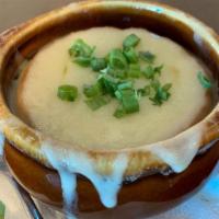 French Onion Soup Au Gratin · Caramelized onions, rich beef broth, toasted garlic croustade, swiss and provolone cheeses.