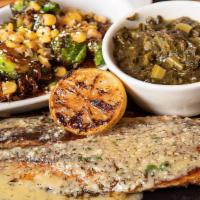 Bronzed Redfish · Garlic butter, grilled lemon, black bean rice, blasted brussel sprouts.