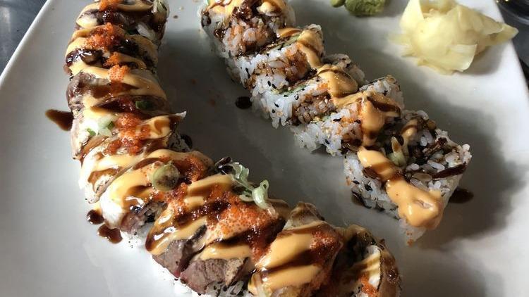 Surf & Turf Roll · Shrimp tempura, avocado, cucumber, cream cheese inside, topped with Seared white fish and beef, eel sauce, spicy mayo and scallion.