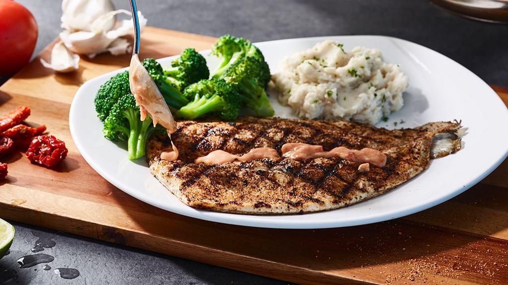 Rainbow Trout · Lightly seasoned and wood-grilled (410 cal), served with choice of sauce and two signature sides.