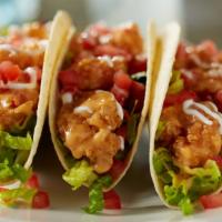 Bang Bang Shrimp Tacos · Three warm tortillas, our signature bang bang shrimp, greens, tomatoes, sour cream, with Fre...