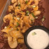 Loaded Sidewinder Potatoes · Fried, twisted potatoes with shredded cheese, bacon, green onions, and sauce.
