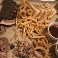 The Hog Trough · Your choice of 3 meats, 5 side items, and 1/2 slab of ribs. Feeds 4-5.