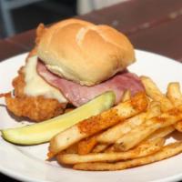 Chicken Schnitzel Sandwich · Our signature Chicken Schnitzel Sandwich is breaded and fried and topped with ham and swiss ...