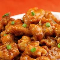 Orange Chicken · Hot chunks of chicken sauteed with orange peel in a spicy sauce. With white rice. Hot and sp...