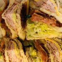 Stacked To The Max Club · Turkey, ham, bacon, lettuce, tomato, mayo and cheese on toasted bread.