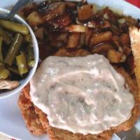 Country Fried Steak W/Gravy · Country fried steak with choice of home hash taters, garlic mashed potatoes or grits.