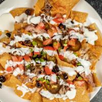 Pulled Pork Nachos · Tortilla chips, pulled pork, cheese, olives, jalapeños, tomatoes, green onion, cilan, tro, c...
