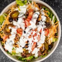 Taco Salad · Seasoned ground beef, romaine, cheese, cilantro, jalapenos, olives, tomatoes, green onions, ...