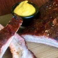 1/2 Rack Pork Ribs · Loin back ribs smoked over locally sourced Hickory.