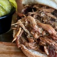 Pulled Pork Sandwich W/ 2 Sides · Pulled pork covered in our dry rub, smoked over locally sourced Hickory and served on a sand...