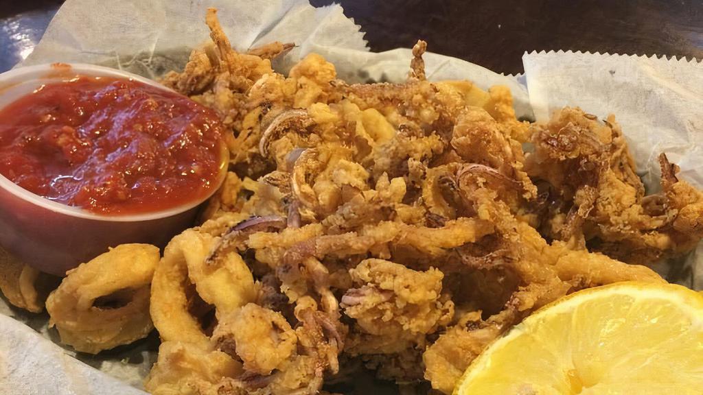 Calamari · Dusted in seasoned flour and fried till golden served with marinara sauce.