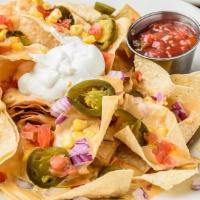 Nachos · Served with cheese sauce, tomatoes, red onions, corn, jalapeños, black beans and sour cream.
