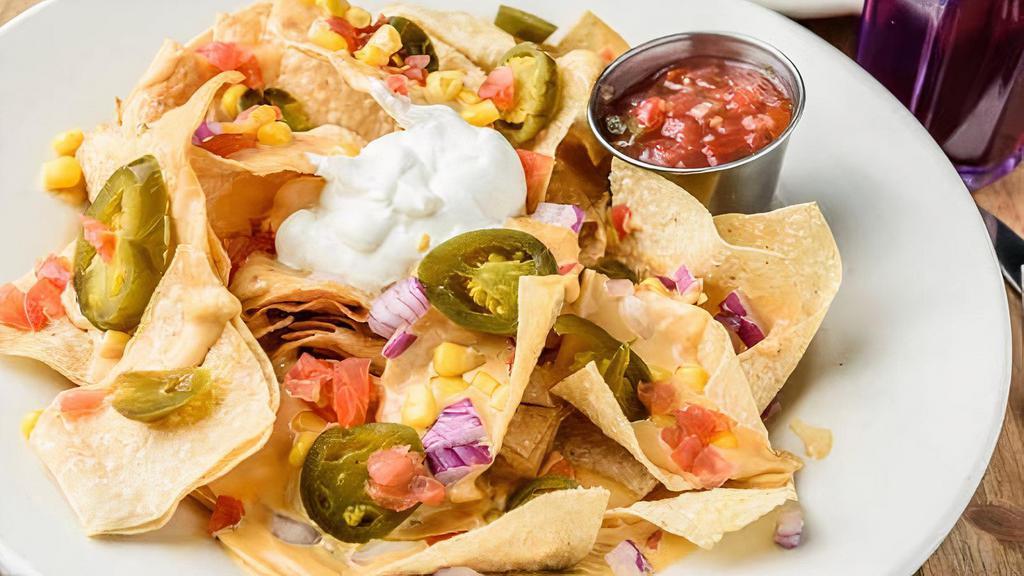 Nachos · Served with cheese sauce, tomatoes, red onions, corn, jalapeños, black beans and sour cream.