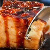 White Chocolate Bread Pudding · with bourbon caramel sauce