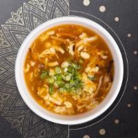 Hot & Sour Soup · Hot and sour soup with lemongrass, mushrooms, tomato, onions, and kafﬁr lime leaves.