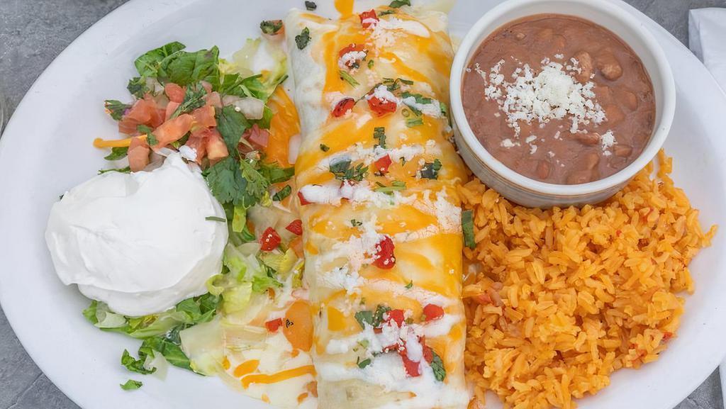 Burrito Special · Special one big flour tortilla filled with grilled chicken, chorizo, rice, and beans. Topped with cheese, pico de gallo and sour cream.