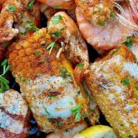 Full Combo · Cajun snowcrab & cajun shrimp with 4. sides topped with Seafood lady sauce and garnished wit...