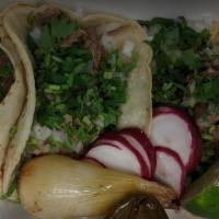 Street Taco · choice of meat, homemade corn tortilla, cilantro, and onions.