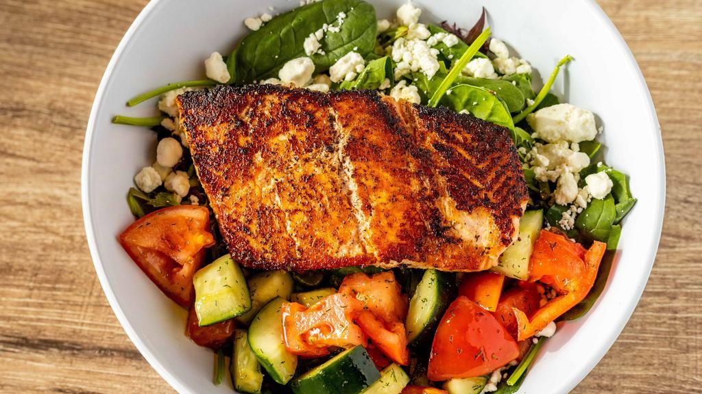 Grilled Salmon Salad · Fresh char grilled salmon filet served over crisp mixed greens, marinated cucumber and tomatoes, goat cheese with choice of dressing.